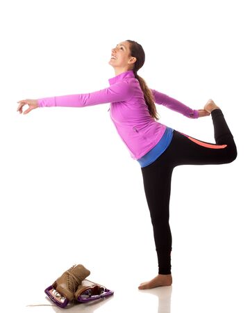 Figure skater stretching. Studio shot over white.の写真素材