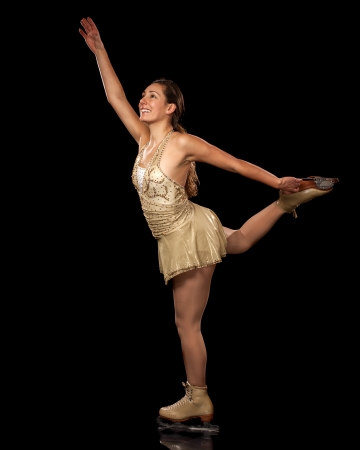 Young adult figure skater  Studio shot over black の写真素材