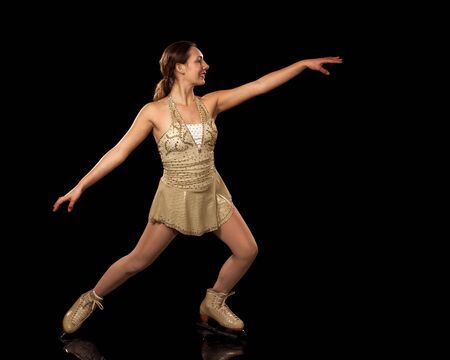 Young adult figure skater  Studio shot over black の写真素材