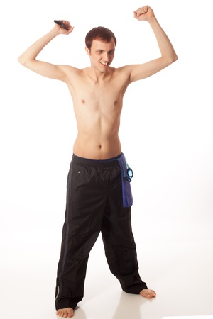Young adult male swimmer cheering on teammates. Studio shot over white.の写真素材