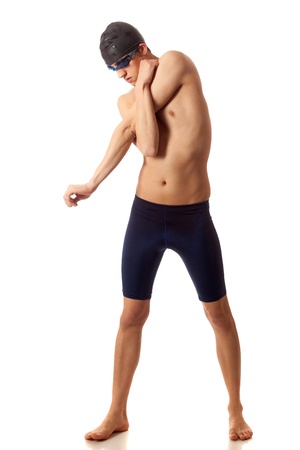 Young adult male swimmer stretching. Studio shot over white.の写真素材
