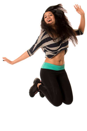 Young woman jumping. Studio shot over white.の写真素材