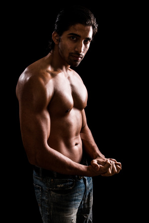 Athletic man, shirtless. Studio shot over black.の写真素材