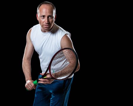 Adult male tennis player. Studio shot over black.の写真素材