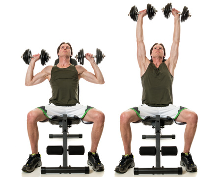 Dumbbell shoulder press exercise. Studio shot over white.の写真素材