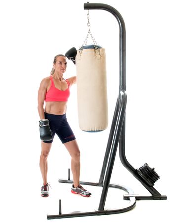 Heavy bag exercise. Studio shot over white.の写真素材