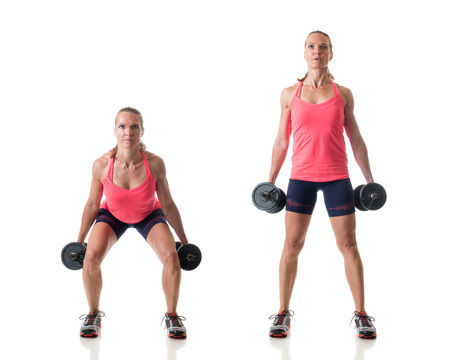 Dumbbell squat exercise. Studio shot over white.の写真素材