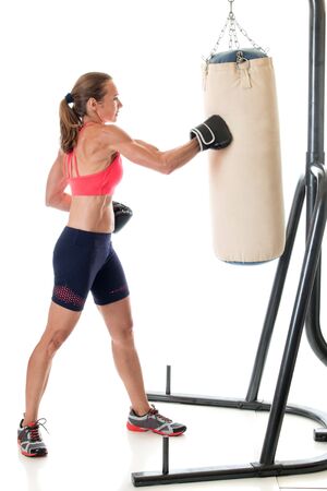 Heavy bag exercise. Studio shot over white.の写真素材