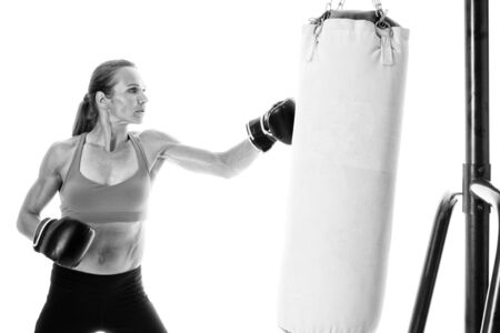 Heavy bag exercise. Studio shot over white.の写真素材