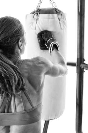 Heavy bag exercise. Studio shot over white.の写真素材