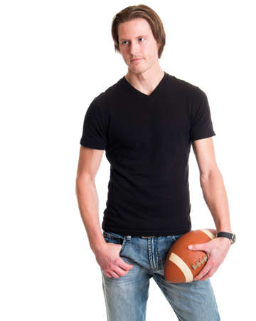 Man in jeans and black tee shirt with football. Studio shot over white.の写真素材