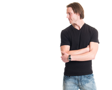 Man in jeans and black tee shirt. Studio shot over white.の写真素材