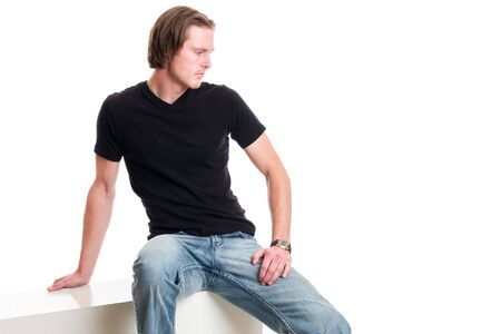 Man in jeans and black tee shirt. Studio shot over white.の写真素材