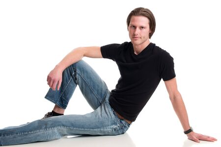 Man in jeans and black tee shirt. Studio shot over white.の写真素材