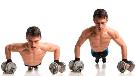 Push-ups with dumbbells. Studio composite over white.の写真素材