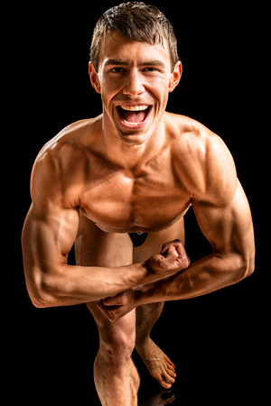 Bodybuilder posing. Studio shot on black.の写真素材