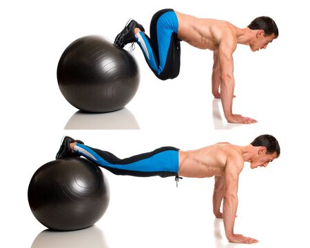 Man exercising with a stability ball. Studio shot over white.の写真素材