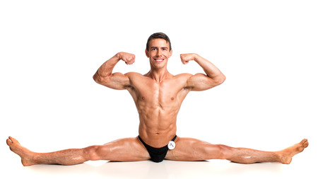 Bodybuilder posing. Studio shot on white.の写真素材