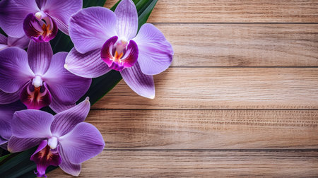 Orchid flowers on wooden background. Top view with copy space.の素材