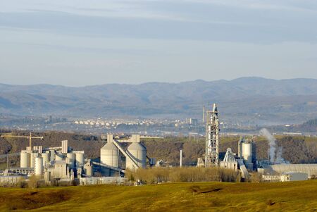 industrial facility next to the town between hillsの写真素材