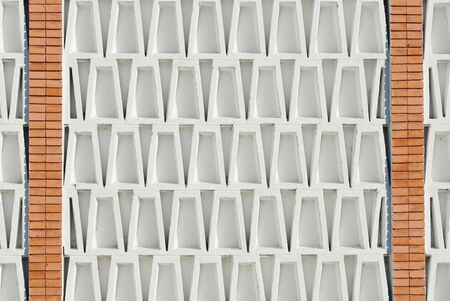 architectural detail background with terracotta bricks and trapezoid concrete bricksの写真素材