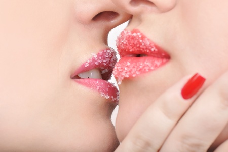 closeup view of two girls faces with beautiful red sweet lipsの写真素材