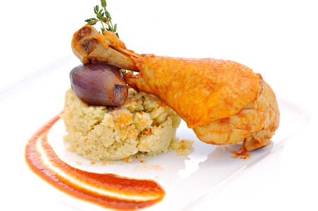 prepared drumstick with onion and cereals on white plateの写真素材