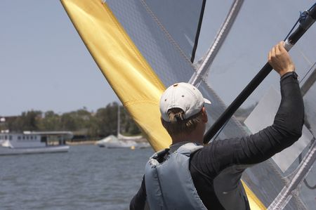 Sailboarder hanging onto the boomの写真素材