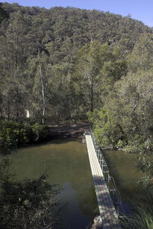 Foot bridge over a riverの写真素材