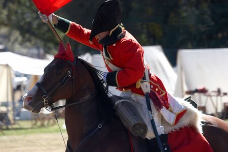 British Redcoat charging on a horse holding a standardの写真素材