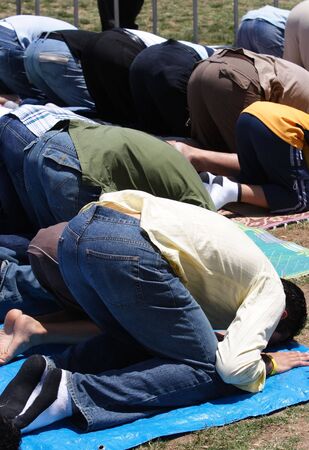 A group of muslims praying outdoorsの写真素材