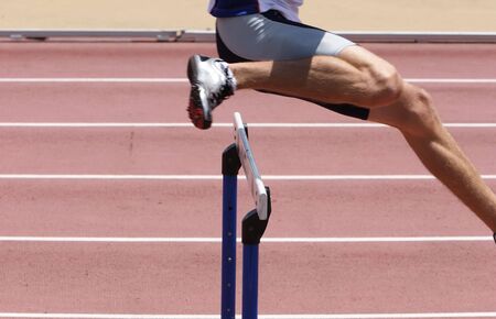 An athlete leaping the hurdlesの写真素材