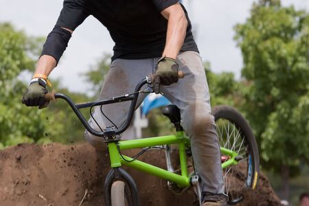 A BMX (Bicycle Moto-cross(X)) going over a dirt moundの写真素材