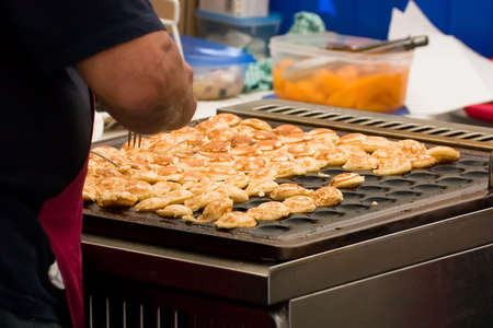 Cooking mini pancakes on the barbecueの写真素材