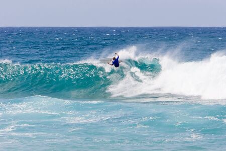 Surfer on the crest of a wave
