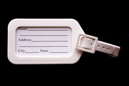 A white luggage tag on a black backgroundの写真素材