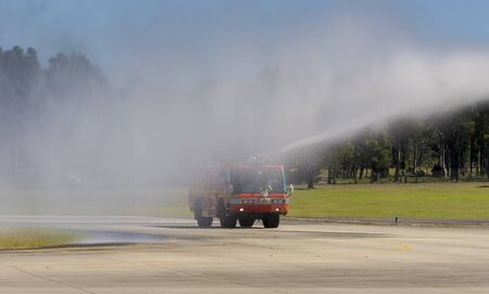 Fire engine with water spraying at an airfield