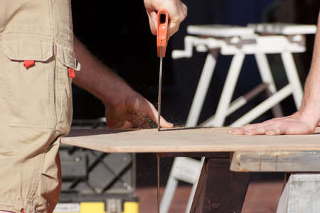 Workers sawing woodの写真素材