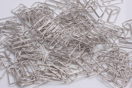 A large number of paper clips on a white surfaceの写真素材