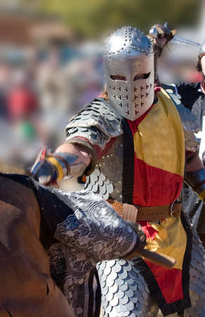 Warrior lunging with his sword, while behind him he is about to be struck