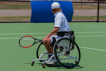 A wheelchair bound athlete on the tennis courtの写真素材