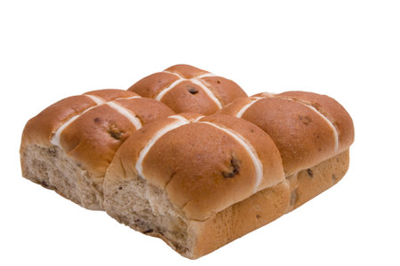 Four Hot Cross Buns against a white backgroundの写真素材
