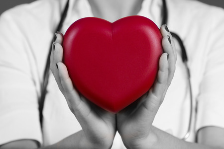 Female doctor holding red heart .Medicine,Health Care,Hospital.の写真素材