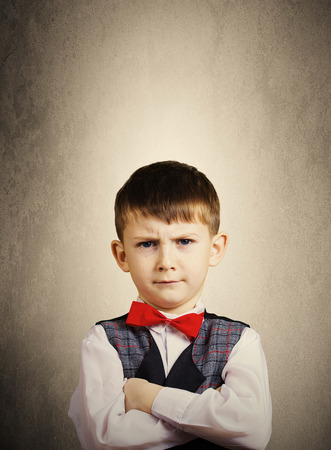 SeriousStubbornsadupset  little boychild  isolated over grey background.Facial expressionの写真素材