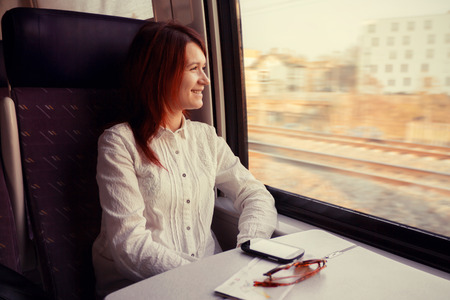 Young woman feeling relaxed traveling in the trainの写真素材