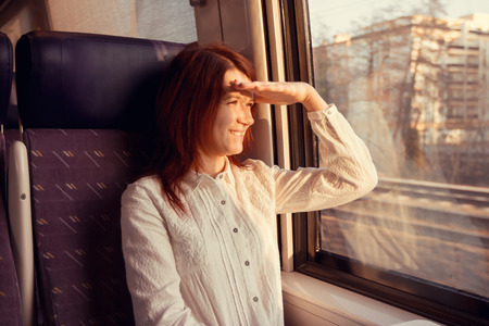 Young woman feeling relaxed traveling in the trainの写真素材