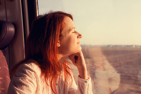Young woman feeling relaxed traveling in the train.の写真素材