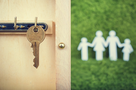 Property insurance and security concept.Wooden Key Holder House with  isolated white backgroundの写真素材