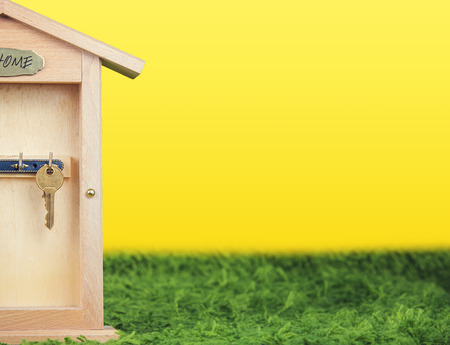 Property insurance and security concept.Wooden Key Holder House with  isolated white backgroundの写真素材