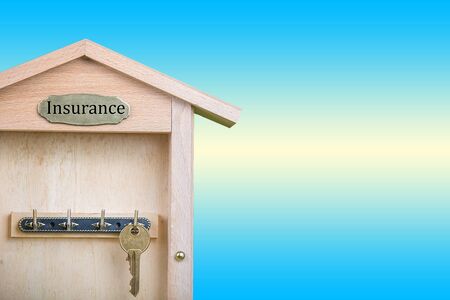Property insurance and security concept.Wooden Key Holder House with  isolated white backgroundの写真素材